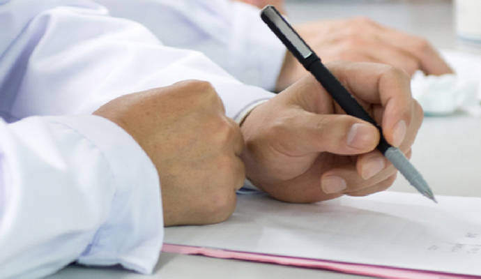 Healthcare professional writing notes