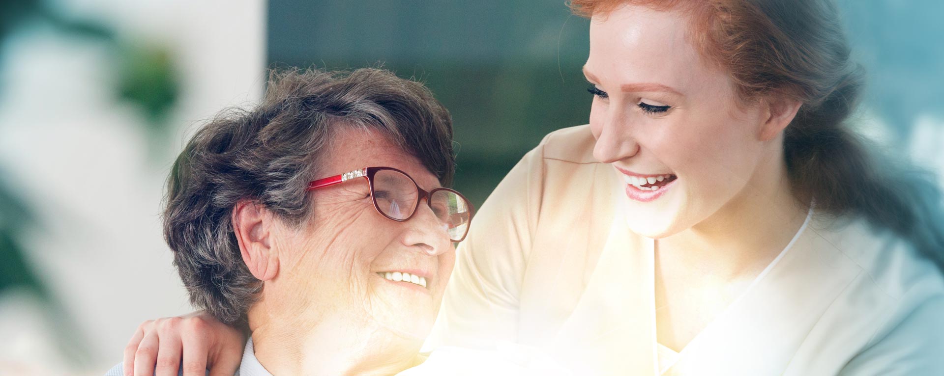 Patient with a kind-looking carer smiling at each other