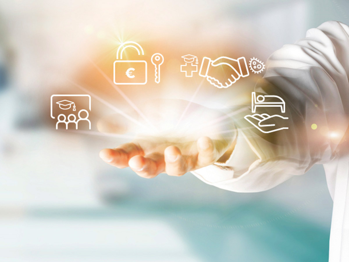 The hand of a healthcare professional holding floating app icons