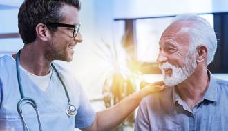 Friendly clinician engaging with a male patient