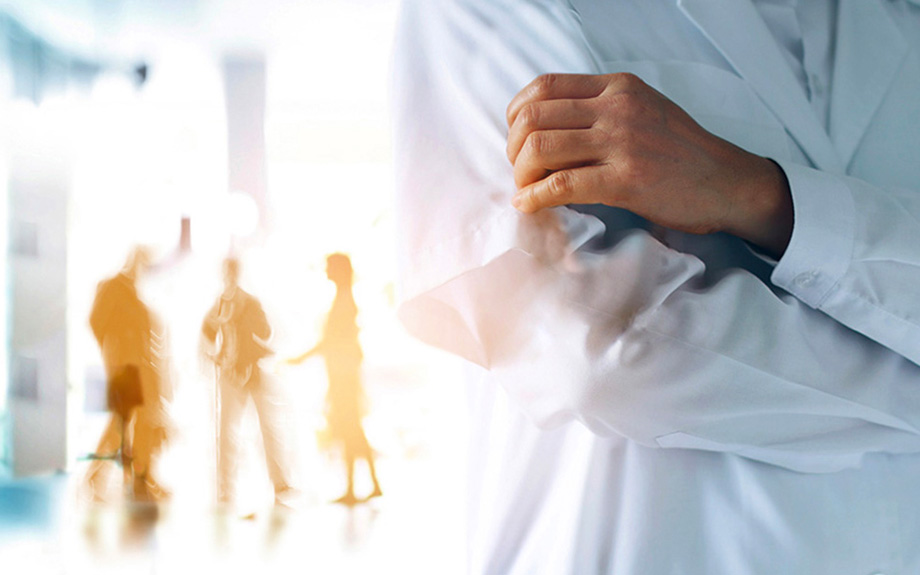 Healthcare professional with blurred-out people in the background