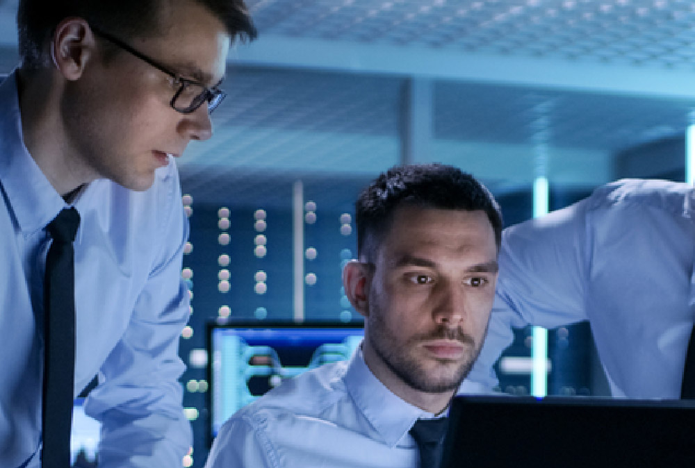 Support technicians looking at a computer